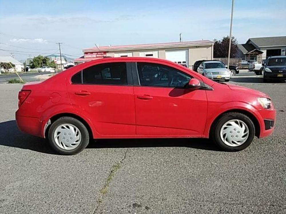 2015 Red Hot Chevrolet Sonic LS Auto Sedan (1G1JA5SH2F4) with an 1.8L L4 DOHC 24V engine, 6-Speed Automatic transmission, located at 1821 N Montana Ave, Helena, MT, 59601, (406) 543-1986, 46.603153, -112.020531 - Photo #1