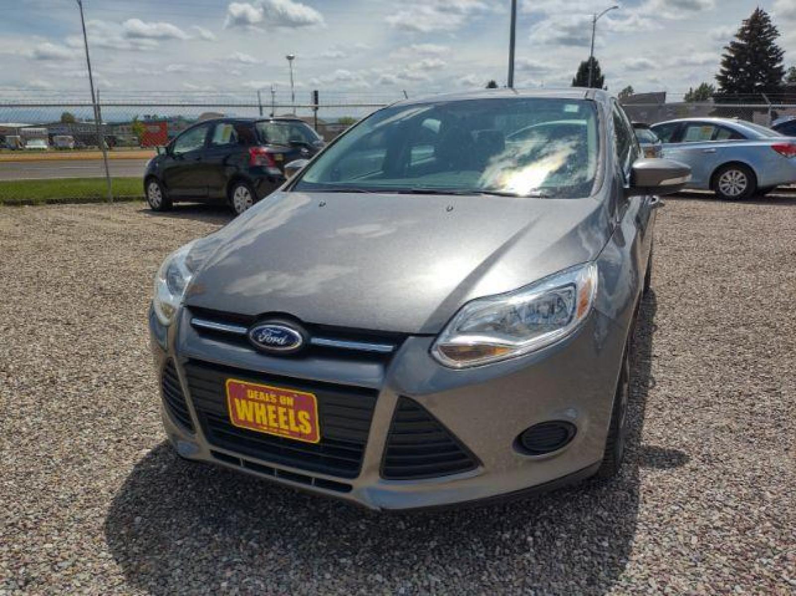 2014 Sterling Gray Metallic Ford Focus SE Sedan (1FADP3F23EL) with an 2.0L L4 DOHC 16V engine, located at 4801 10th Ave S,, Great Falls, MT, 59405, (406) 564-1505, 47.494347, -111.232239 - Photo #0